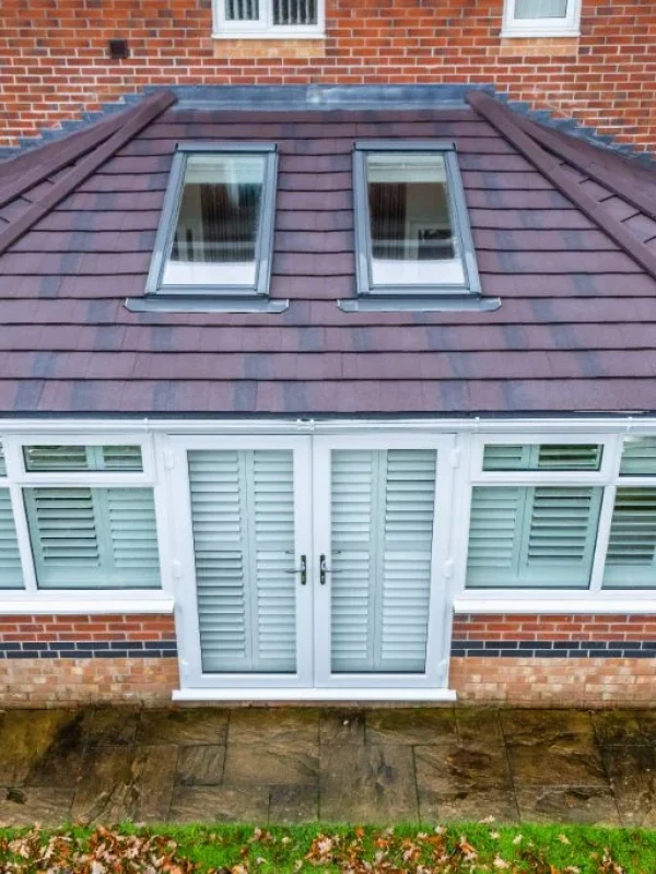 Conservatory warm roof installation with lightweight tiled roof and Velux roof windows in North Wales